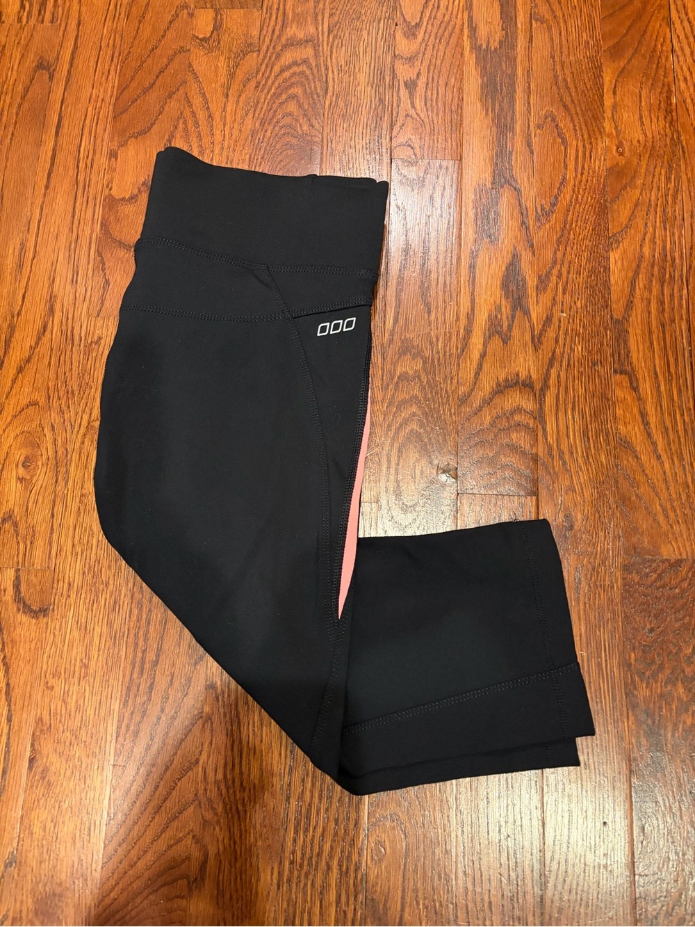 Lorna Jane Black Crop Leggings with peach/Pink Side Stripe. Size M